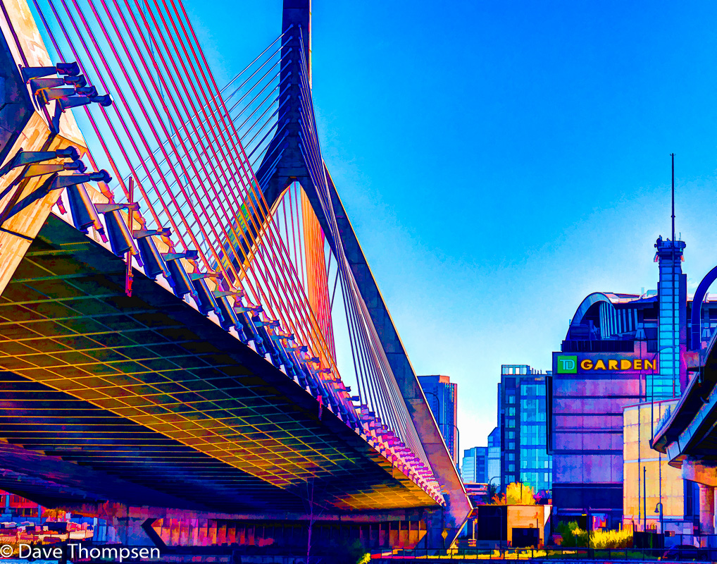 A artistic photograph of the Leonard P. Zakim Bunker Hill Memorial Bridge with the Boston Garden in the background.