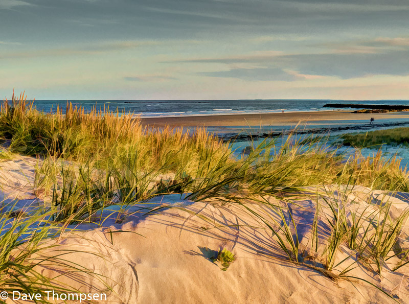 A photograph taken behind a sand dune along Hampton Beach in New Hampshire.